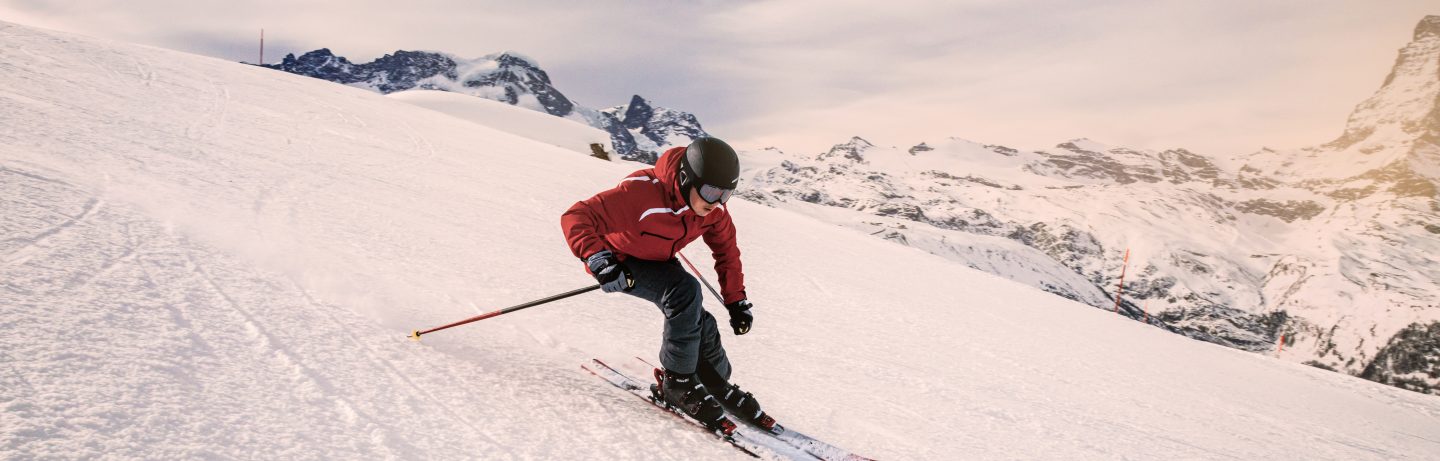 Young skier downhill skiing at Zermatt ski resort with Matterhorn mountain in background, Valais canton, Switzerland, in winter morning. Taken by Sony a7R II, 42 Mpix.